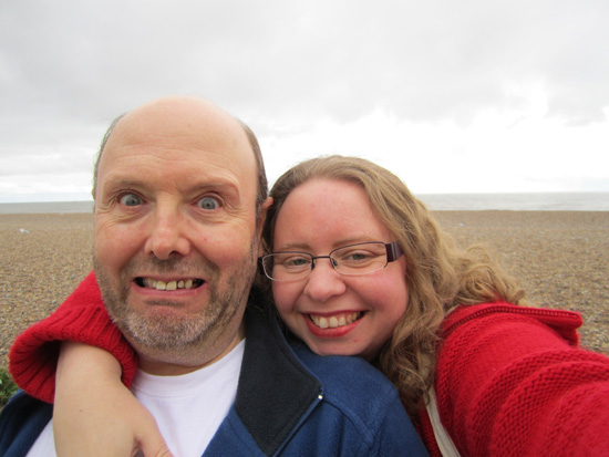 While at the beach, the Fairy tries to take an anniversary photo of the Goblin...
