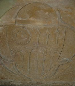 One of the coat of arms on the font.
